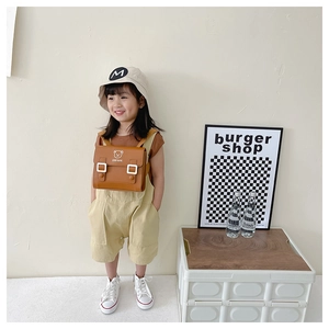 Toddler modeling brown bear PU leather backpack with Stay Cute print and flip cover