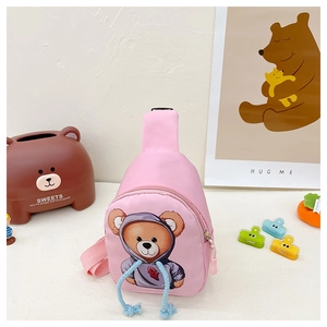 Detail of pink canvas kids crossbody bag featuring a cute cartoon bear and blue drawstring