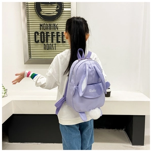 Detail of cute purple kids rabbit backpack with 3D ears and soft plush tail on the back