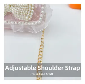Detail show of adjustable gold chain strap on pink pearl lace bow handbag