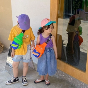 Kids trendy crossbody chest bags in vibrant contrast colors worn by models outdoors