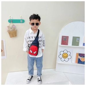 Detail of red and blue kids crossbody bag with Spider-Man mask motif and canvas texture