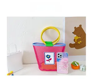Detailed size comparison of a colorful mesh tote bag for kids with bright floral embroidery