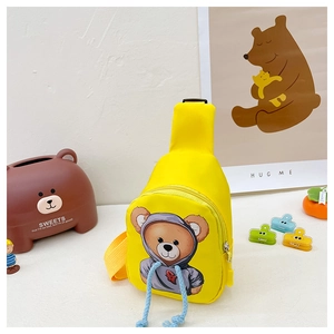 Close-up of yellow canvas kids bag featuring a cute cartoon bear and blue drawstring details