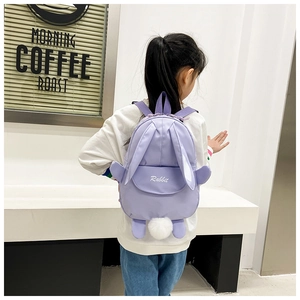 Rear view of child wearing cute lavender rabbit backpack with 3D ears and pom-pom tail