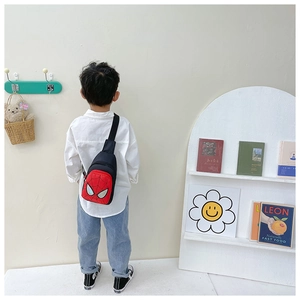 Rear view of a child wearing a Spider-Man style red and black canvas crossbody chest bag