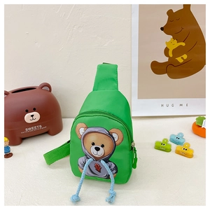 Detail of green nylon kids chest bag featuring a cute cartoon bear and blue woven ropes