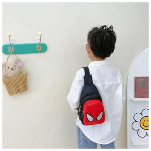 Detail of child wearing a red and black Spider-Man inspired crossbody chest bag