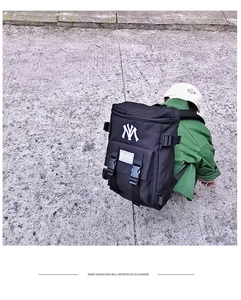 Detailed view of nylon backpack with NY embroidery and dual clip-on buckle flap closure