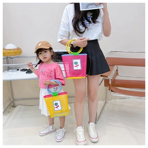 Detail of mesh tote bags with flower patches in pink and yellow for mothers and kids