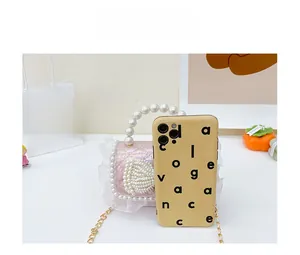 Mini pink pearl handbag with lace trim compared to a smartphone for scale reference
