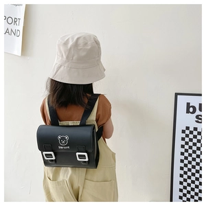 Close-up of black PU leather kids backpack with cute bear print and Stay Cute text