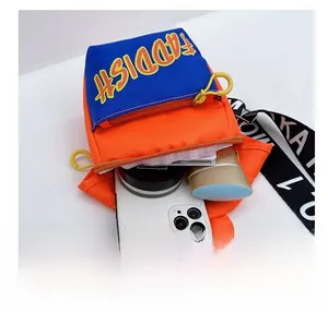 Detail showing internal capacity of the orange and blue crossbody bag for kids