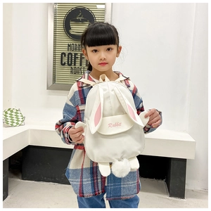 Detailed view of cute white canvas toddler backpack with bunny ears and fuzzy pompom