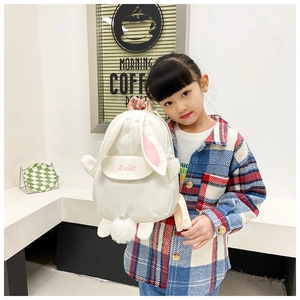 Detail of cute white rabbit canvas backpack featuring pink ears and plush tail ball