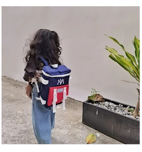 Detail of kids lightweight nylon backpack with NY embroidery and red contrast pocket