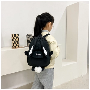 Detail view of the black canvas rabbit backpack featuring long ears and white pompom tail