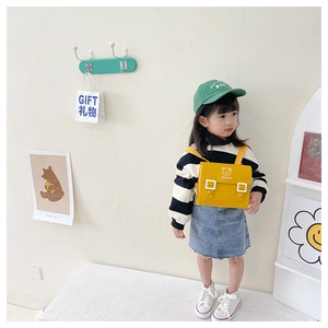 Kid wearing yellow PU bear crossbody bag with STAY CUTE print and adjustable strap