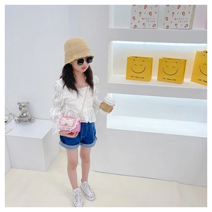 Pink bow pearl strap crossbody bag for girls paired with stylish kid casual outfit