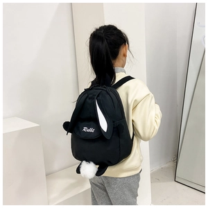 Close-up of cute rabbit canvas backpack featuring long bunny ears and white pom-pom tail