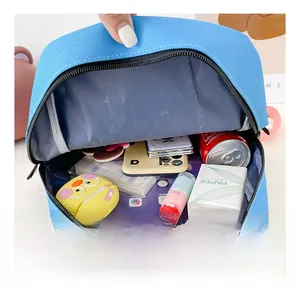 Internal capacity view of light blue canvas school bag for kids with daily essentials
