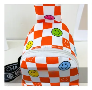 Close-up of kids checkered chest bag with colorful smiley face prints and white zipper