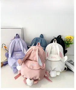 Detail showing plush pom-pom tail and cute rabbit ears on these canvas mini backpacks