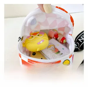 Macro shot showing internal capacity of kids plaid bag with small accessories