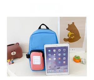 Detailed size comparison of the blue and pink canvas kids backpack next to an iPad