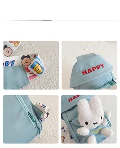 Detail of light blue kids chest bag with plush rabbit toy and cartoon strap