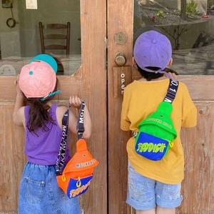 Outdoor scene showing children wearing vibrant color-block crossbody bags with letter prints