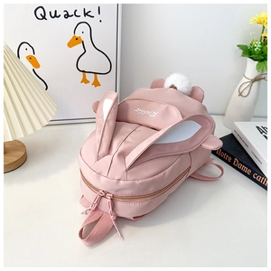 Close-up of pink rabbit backpack with 3D ears, plush tail, and Rabbit embroidery detail
