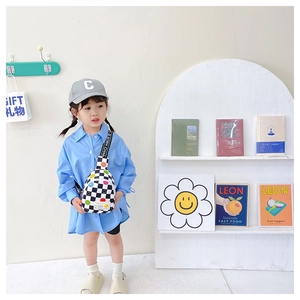 Girl wearing a trendy checkered kids chest bag with colorful smiley face icons and letter strap