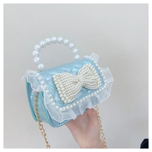 Detail of laser blue sequin bag with lace trim, pearl bow, and gold chain strap
