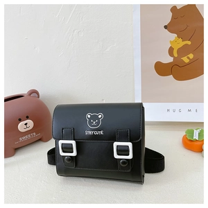 Detail of a black PU leather crossbody bag with white bear print and stay cute text