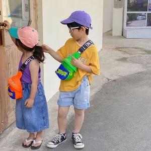 Close-up of vibrant neon color-block kids crossbody bags with letter printed straps