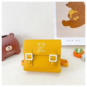 Detail of yellow PU leather kids bag featuring a cute bear print and stay cute text