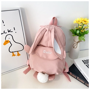 Close-up of pink canvas rabbit backpack featuring long ears and embroidered detail