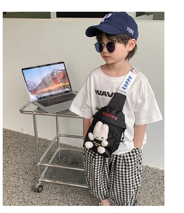Detailed view of kids black chest bag with plush rabbit character and HAPPY print