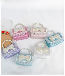 Detail view of mini princess handbags with pearl handles and lace trim in various colors