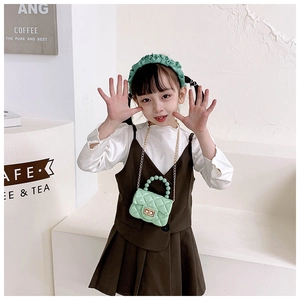 Detail of mint green PVC quilted bag with pearl chain handle for girls' princess style