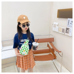 Detailed close-up of a kids checkerboard crossbody bag with cute smiley face patterns