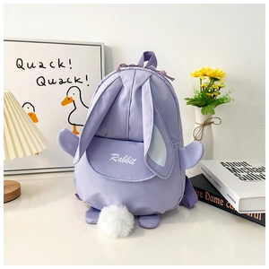 Detail of light purple bunny backpack with long ears and plush ball tail accessory
