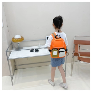 Detail view of lightweight orange children backpack with stylish contrasting pockets
