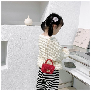 Detail of red quilted jelly bag with pearl handle on model showing size and fit