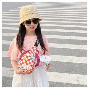 Close-up of child orange checkerboard sling bag with colorful smiley face prints