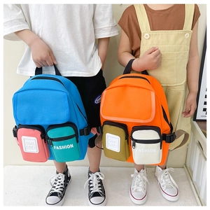 Close-up of kids' canvas backpack featuring blue and orange color-blocking with multi-pockets