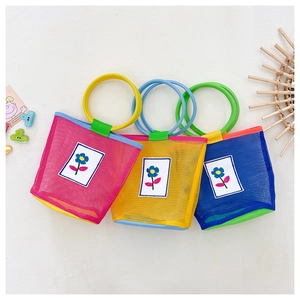Three colorful mesh bags for kids with flower patches and contrasting round handles