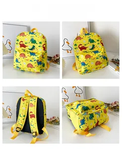 Detail view of yellow dinosaur backpack showing front, side, and back adjustable straps