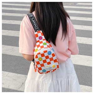 Detail of checkered kids chest bag with smiley patch and lettered shoulder strap